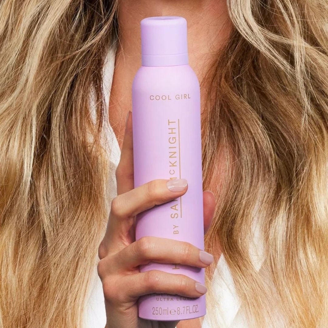 Hair by Sam McKnight Cool Girl Barely There Texture Mist 250ml held against textured blonde hair