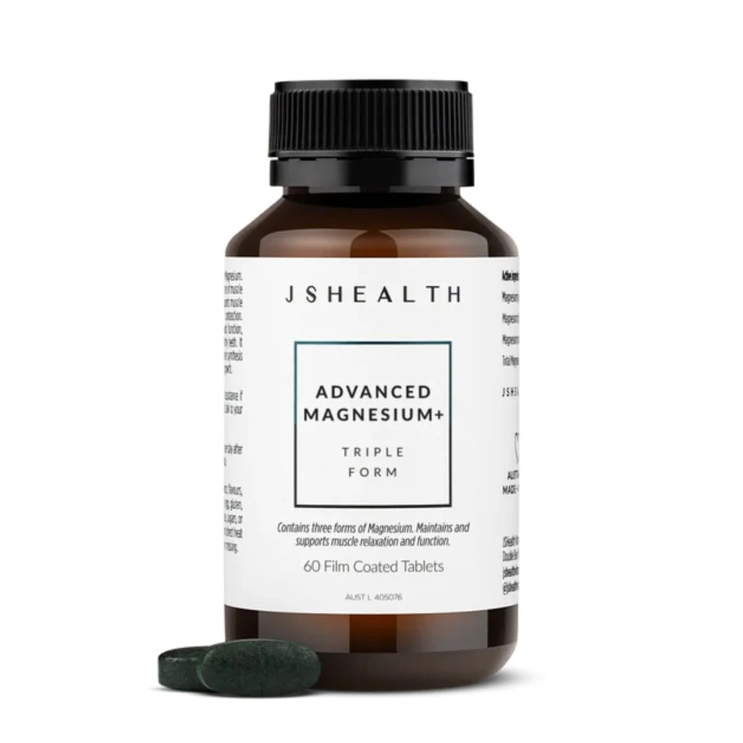 A bottle of JSHEALTH Advanced Magnesium+ Triple Form tablets with two dark green tablets placed in front, on a clean white background.