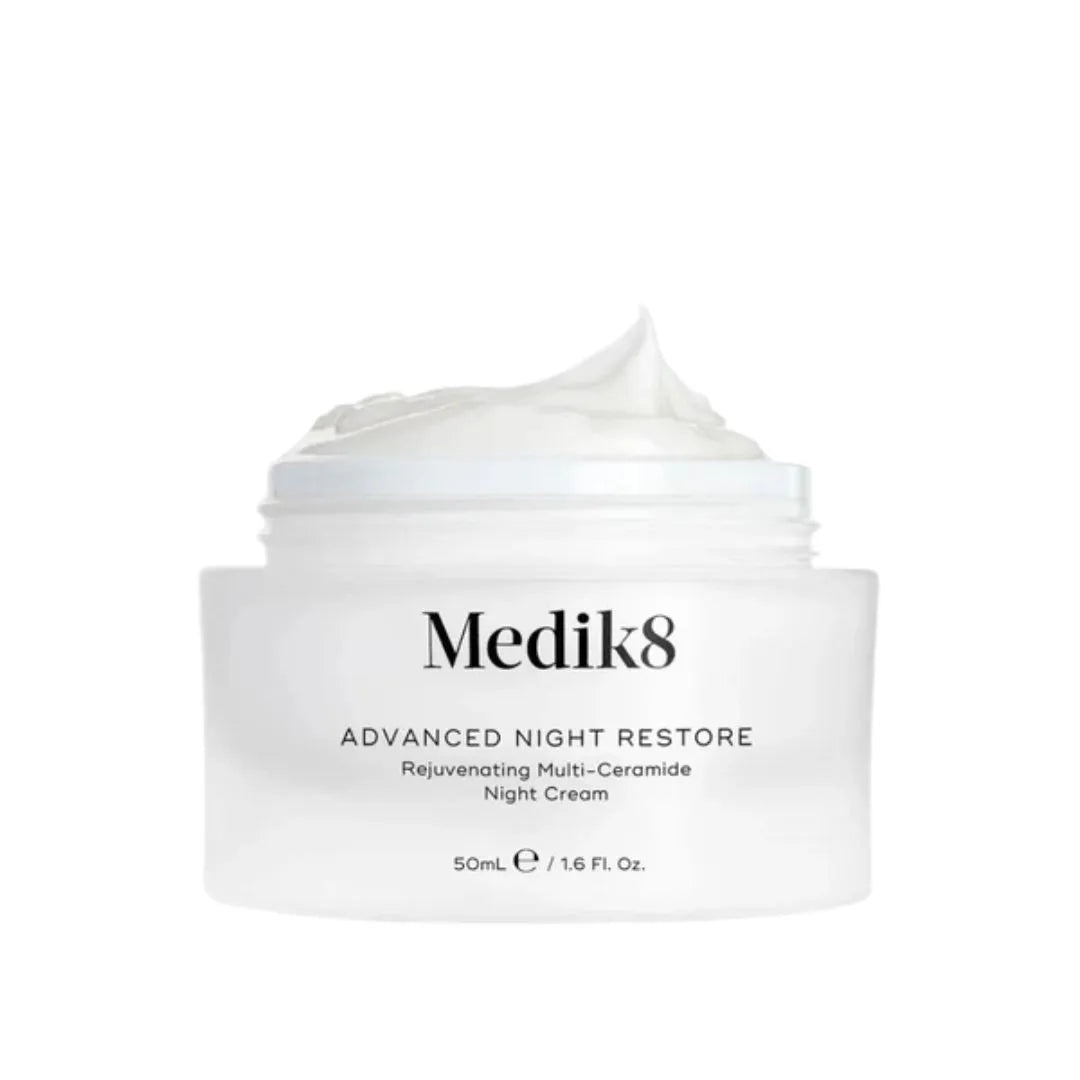 A white jar of Medik8 Advanced Night Restore Rejuvenating Multi-Ceramide Night Cream with a swirl of cream visible at the top, set against a plain white background.