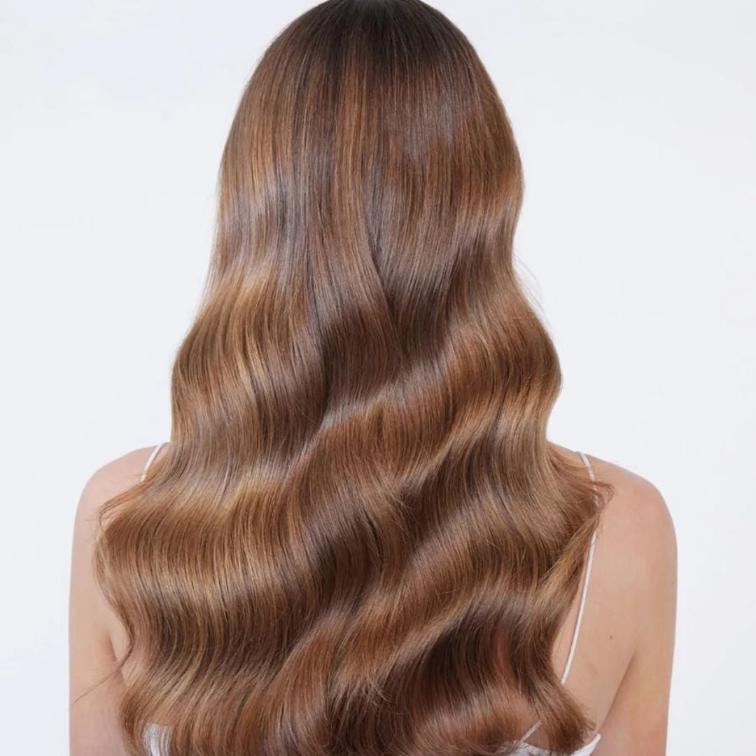Hair by Sam McKnight Rich Nourish Conditioner for smooth shiny and manageable hair. Long, wavy brown hair with warm caramel highlights.