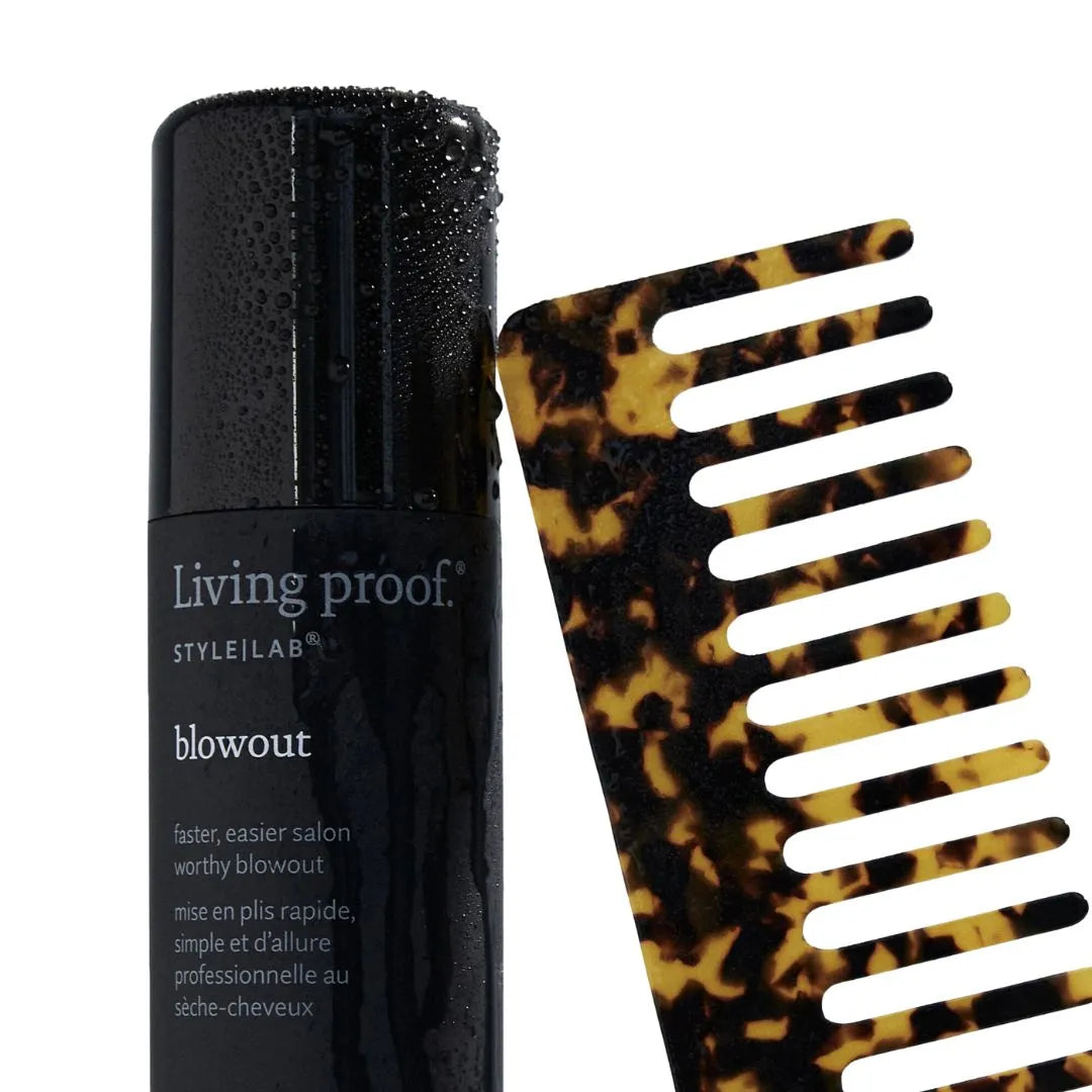 Living Proof hair product bottle with a tortoiseshell comb on a white background