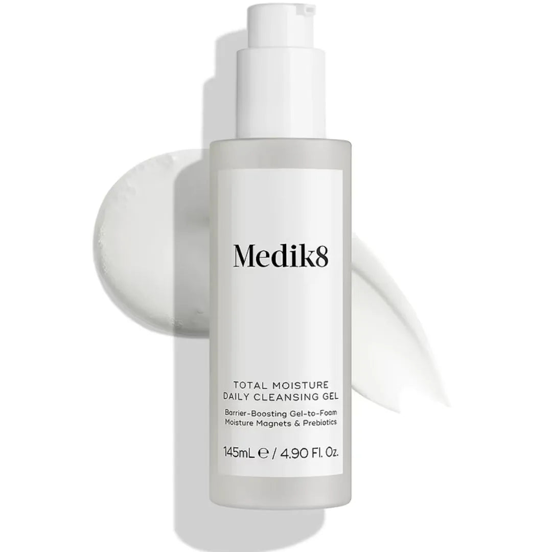 Medik8 Total Moisture Daily Cleansing Gel in a frosted glass pump bottle with a white label, set against a white background with a soft circular gel smear behind it.
