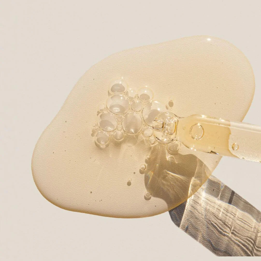 Alpha-H Vitamin C Brightening Serum 10% 15ml – lifestyle shot: mini bottle styled alongside the full-size 25ml