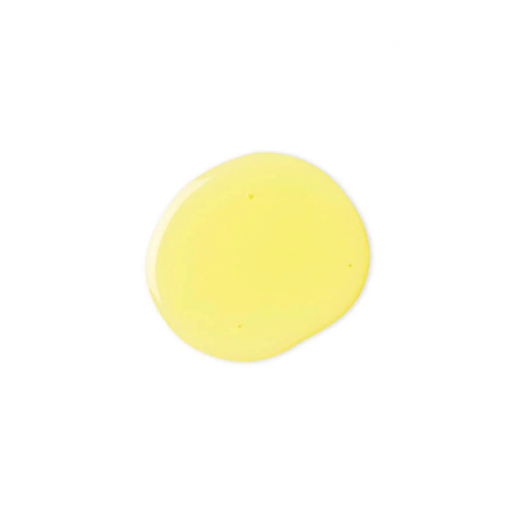 A dollop of pale yellow cosmetic cream or gel on a solid white background.