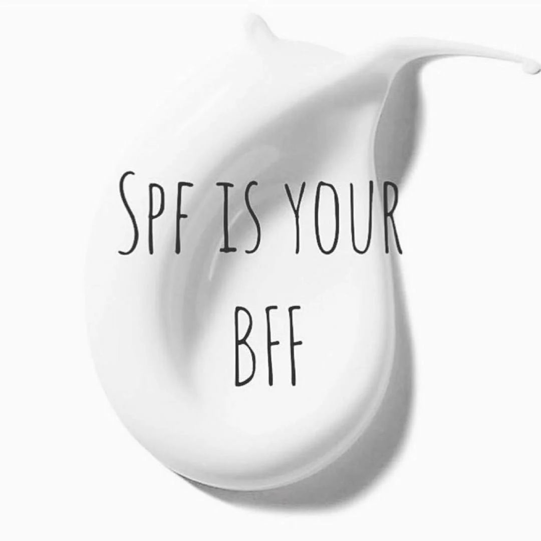 A white cream-colored droplet or smear of sunscreen with the text 'SPF IS YOUR BFF' written in black handwritten font across the center, on a white background.
