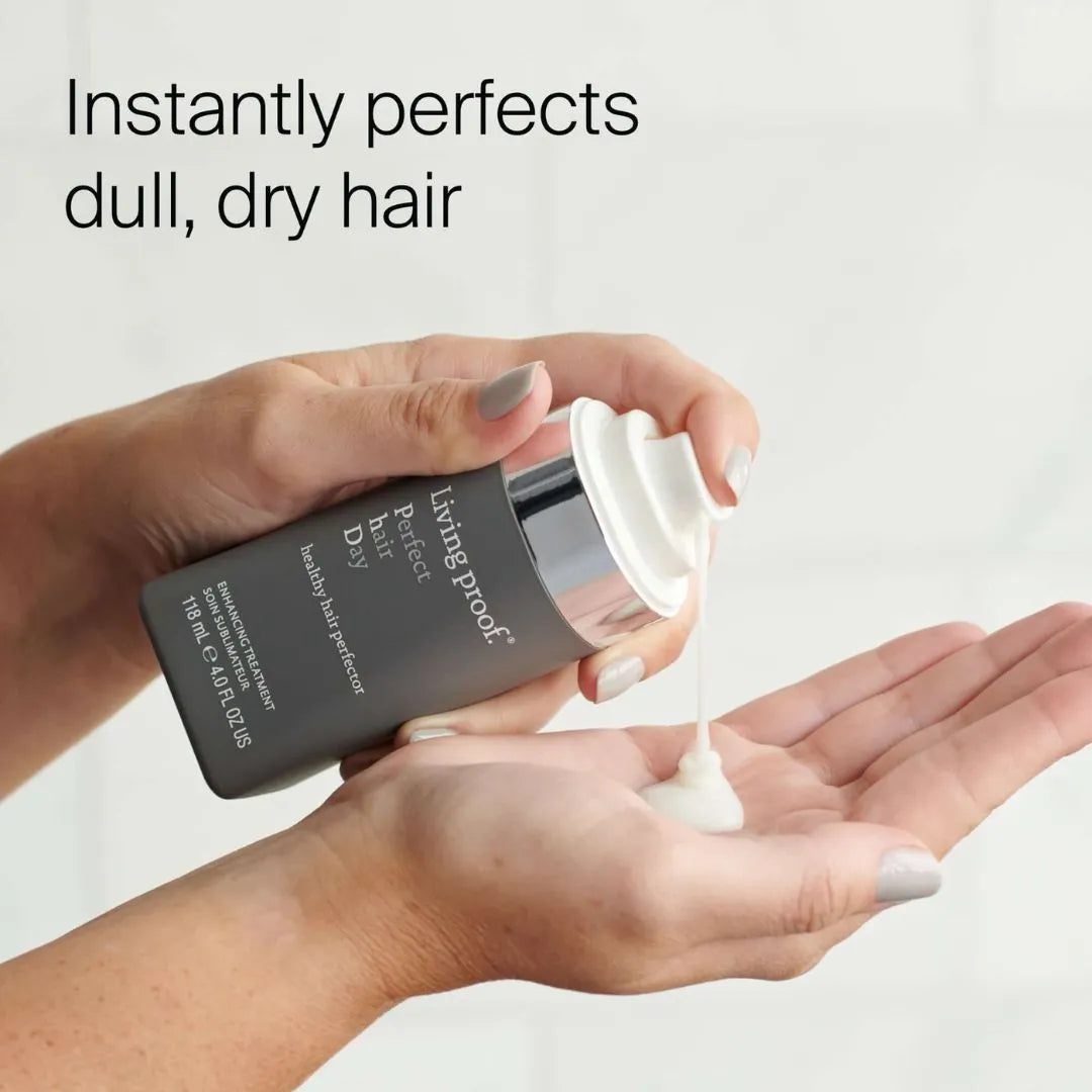 Living Proof Perfect Hair Day Healthy Hair Perfector 118ml – lifestyle shot: model holding bottle with key claim callout on light background