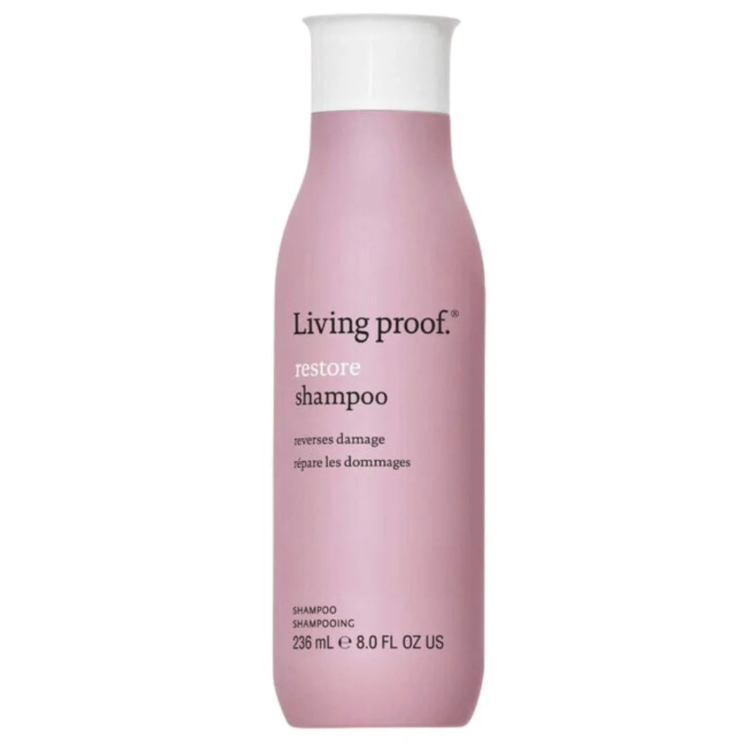 A bottle of Living Proof Restore Shampoo in a dusty pink color with a white cap, shown against a plain white background.