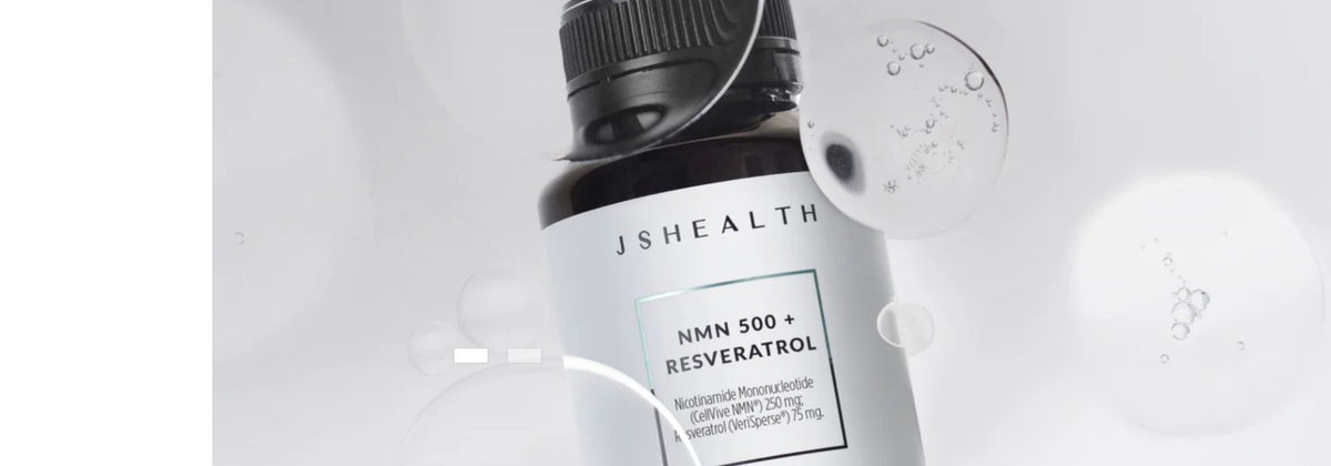 A bottle of JSHEALTH NMN 500 + Resveratrol dietary supplement, featuring a dark bottle with a white label and black cap, set against a light gray background with floating glass bubble graphics.