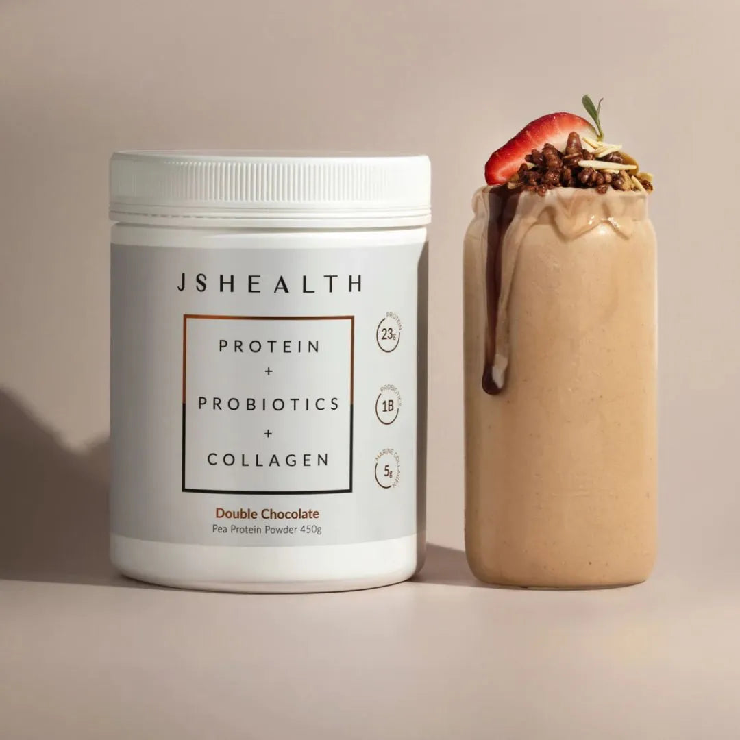 JS Health protein powder container next to a protein shake with toppings on a neutral background