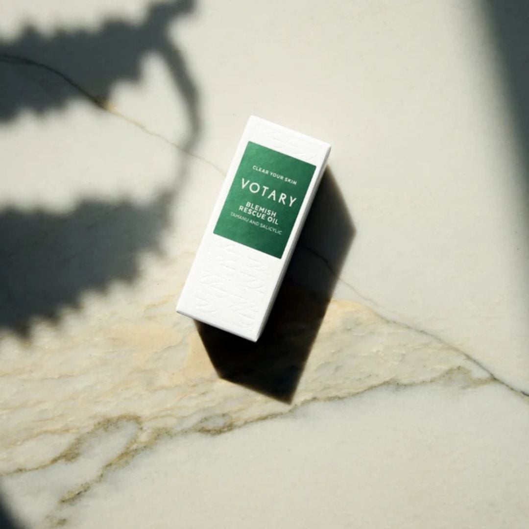 Votary Blemish Rescue Oil with Tamanu and Salicylic product box displayed in natural light