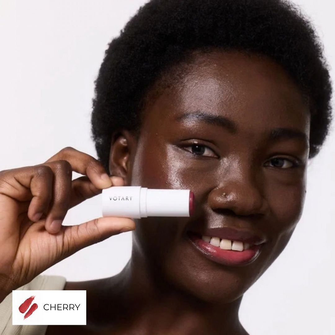 Votary Lip & Cheek Tint in Cherry held beside face
