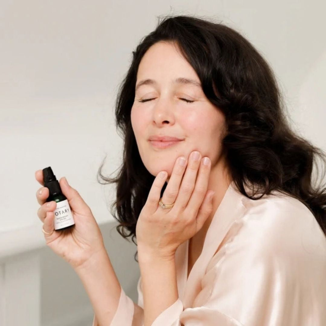 Woman applying Votary Super Bright Eye Gel with green tea and peptides around the eye area