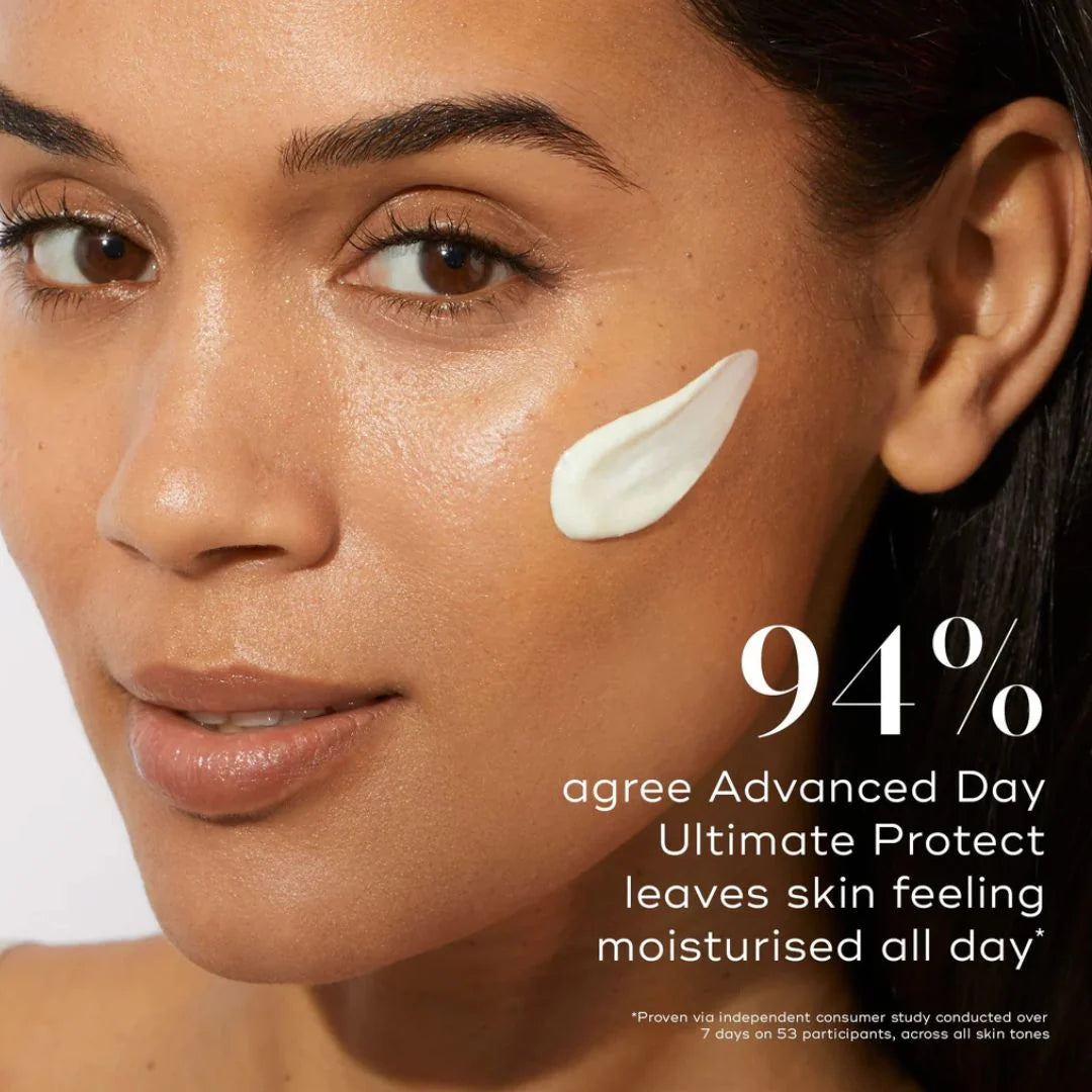 Close-up of a woman's face with a white cream swatch on her cheek and promotional text reading '94% agree Advanced Day Ultimate Protect leaves skin feeling moisturised all day'.